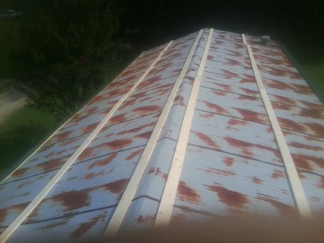 Rusted metal roof panels with new wood purlins before replacement in Walkersville