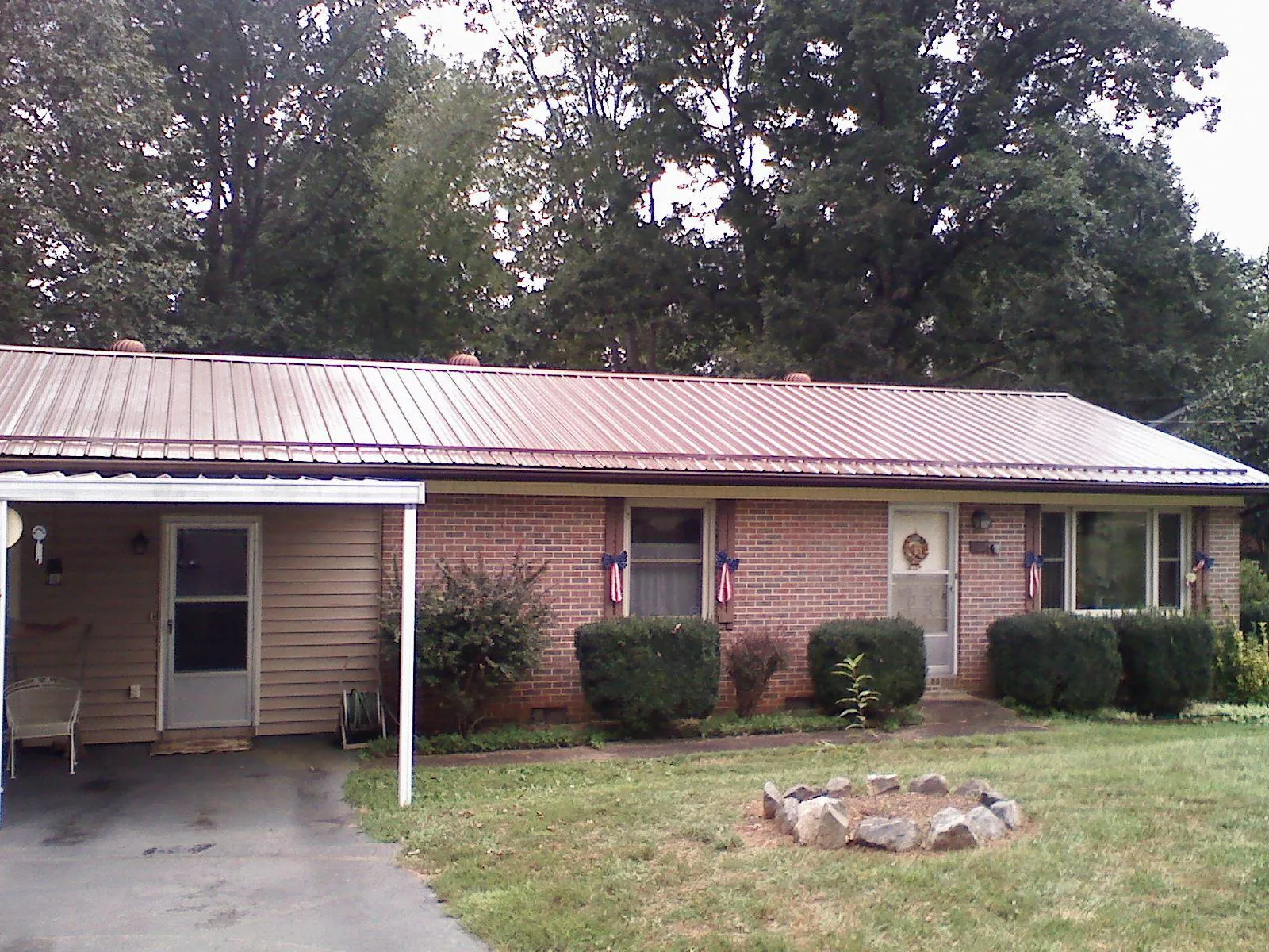 Bronze metal roof and carport on a brick ranch home — Roof Repair work by our crew in Walkersville