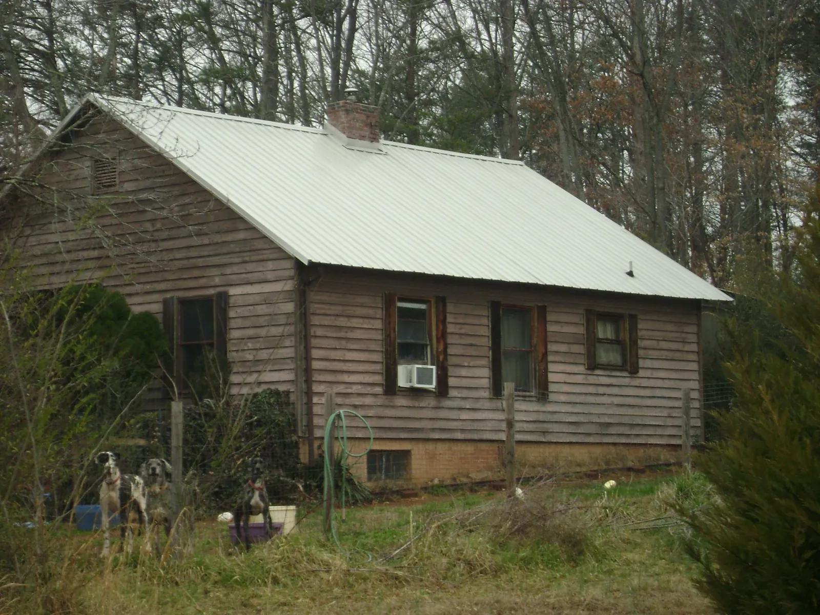 White metal roof on an old wood sided farmhouse, from a Asphalt Shingle Roof Repair job in Walkersville